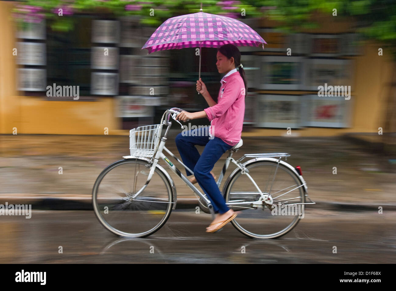 Vietnamese girl cycling in the rain, Hoi An, Vietnam Stock Photo Alamy