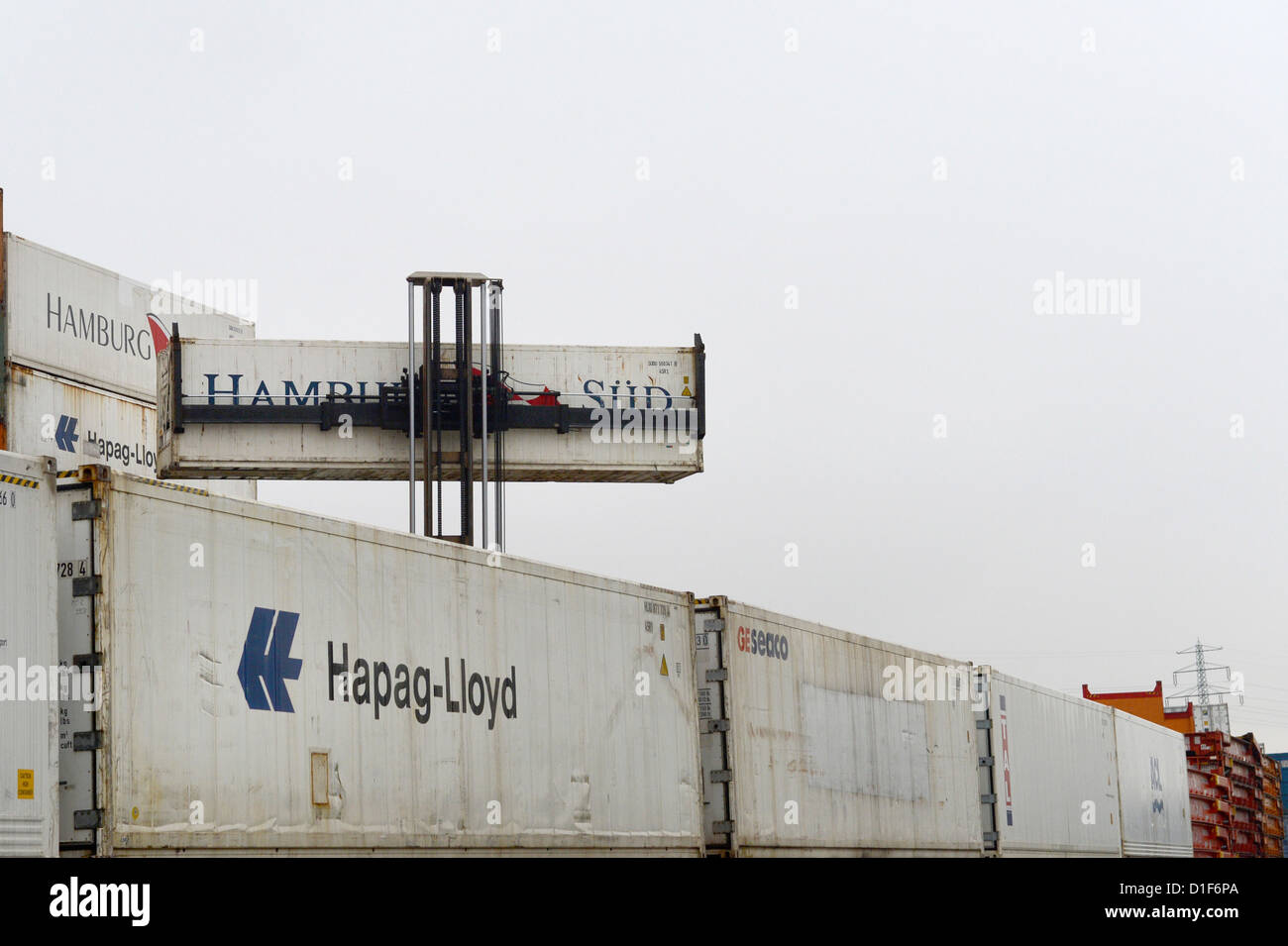 Containers of the Hamburg Sued shipping company are transported away ...