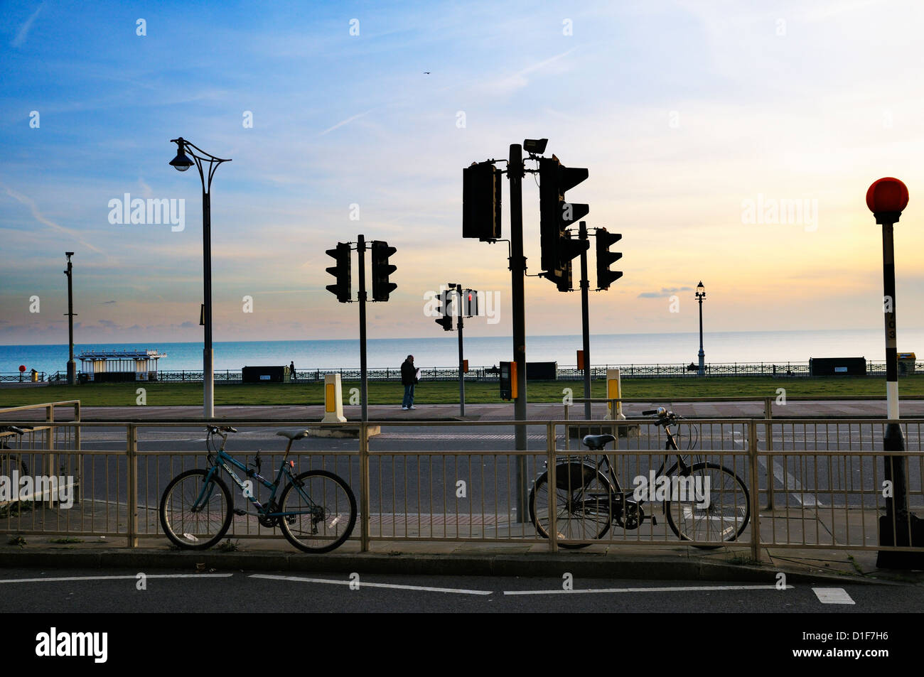 Traffic lights and road crossing at sunset, Brighton, East Sussex, UK