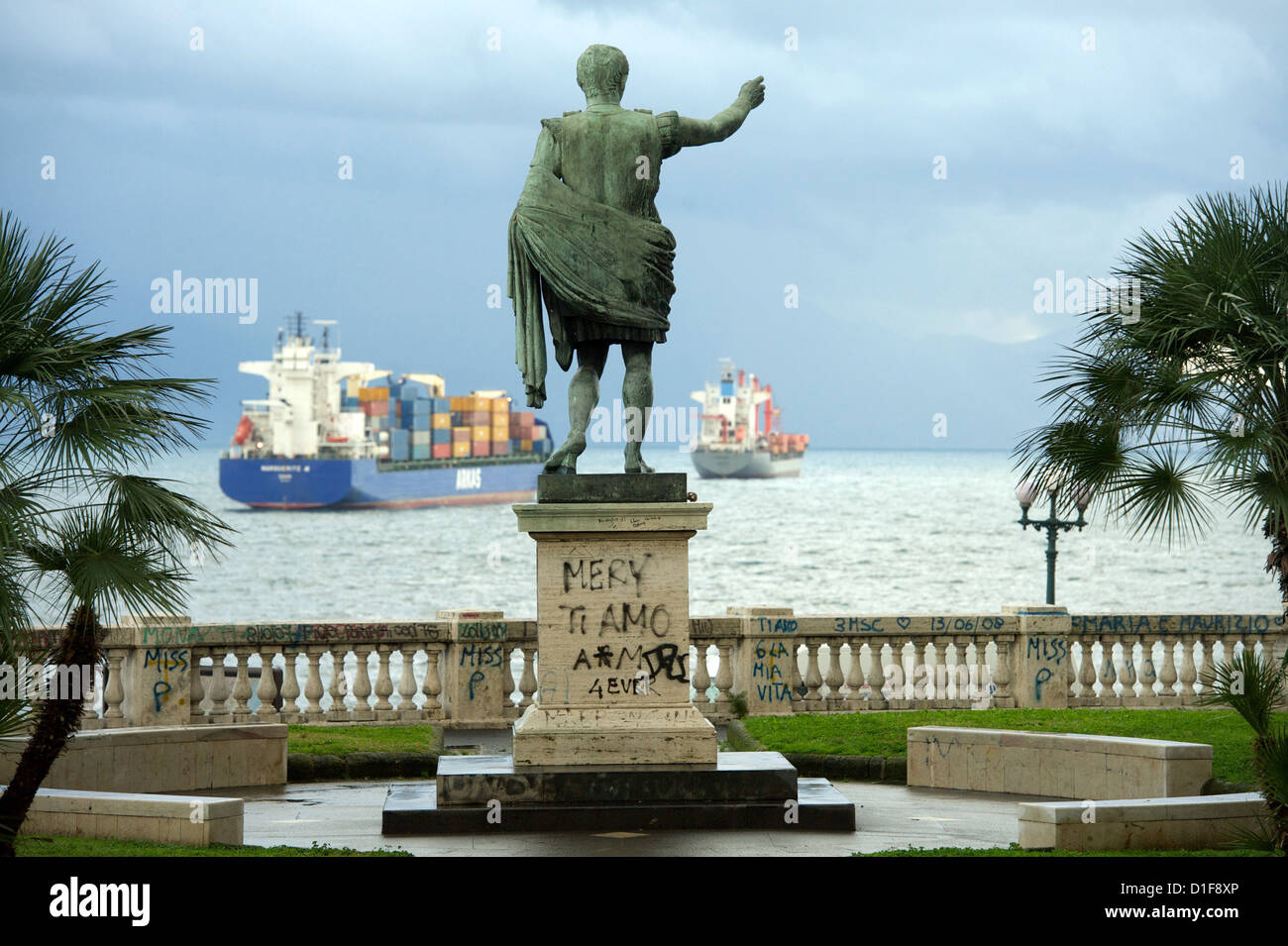 Container ships are moored behind a Julius Caesar statue in Naples, Italy, 01 December 2012. Photo: Peter Endig Stock Photo