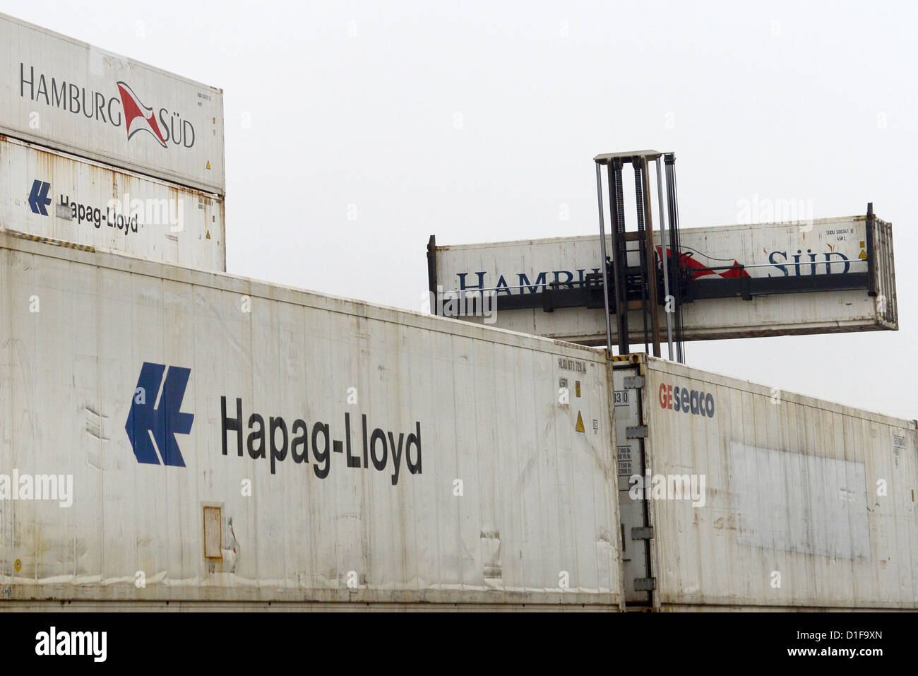 Containers of the Hamburg Sued shipping company are transported away