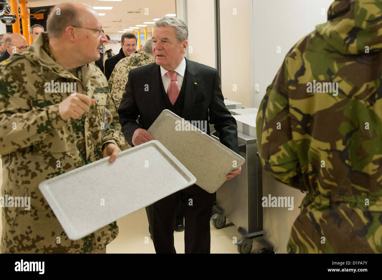 German President Joachim Gauck (M) stands next to German Major General Erich Pfeffer (L) as he visits the German Armed Forces at Camp Marmal in Masar-i-Sharif, Afghanistan, 18 December 2012. Photo: Maurizio Gambarini Stock Photo