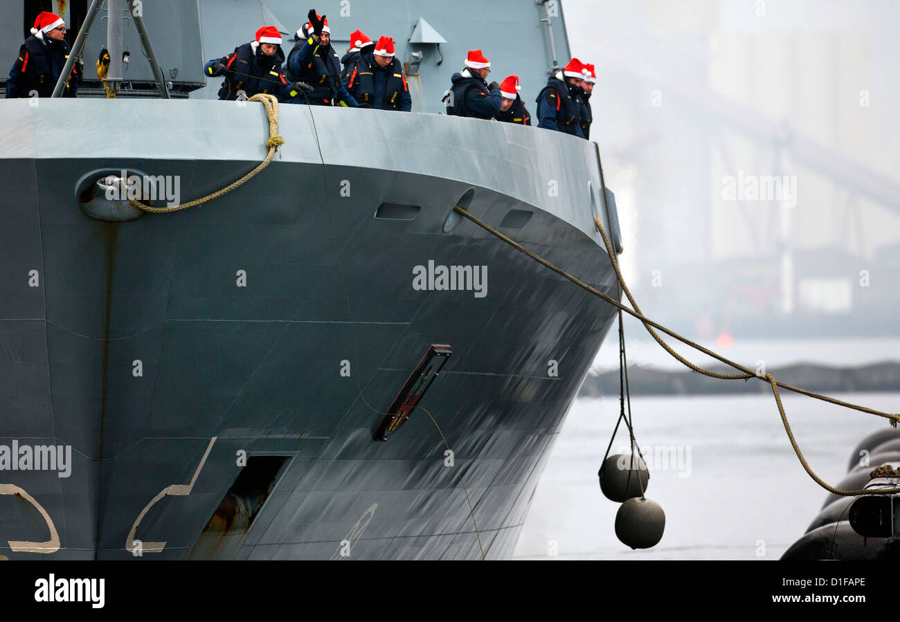 Crew members are on deck of the corvette 'Magdeburg' as they return from their Lebanon mission to Rostock-Hohe Duene, Germany, 19 december 2012. The 58 marines were stationed at the Lebanese coast for three months. Photo: JENS BUETTNER Stock Photo
