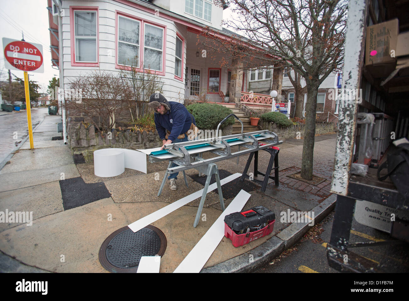 Atlantic City, New Jersey - A worker fashions new rain gutters for a house damaged by Hurricane Sandy. Stock Photo