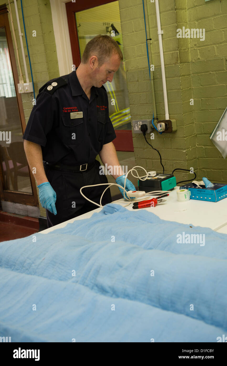 Elderly people bringing their electric blankets to Aberaeron fire station for safety testing organised by AGE Cymru.  Wales UK Stock Photo