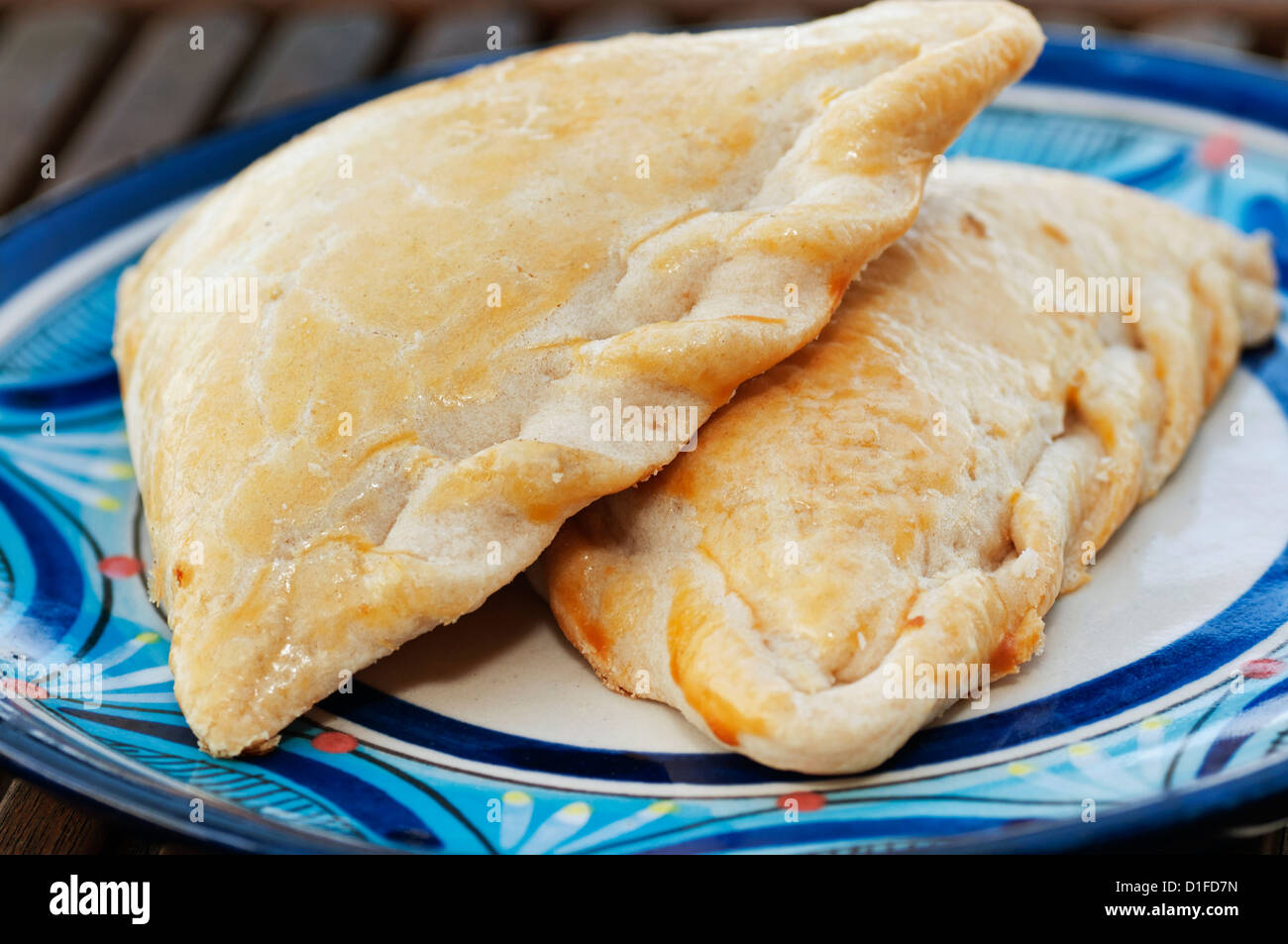 A plate is filled with two Mexican dessert empanada pastries. Stock Photo