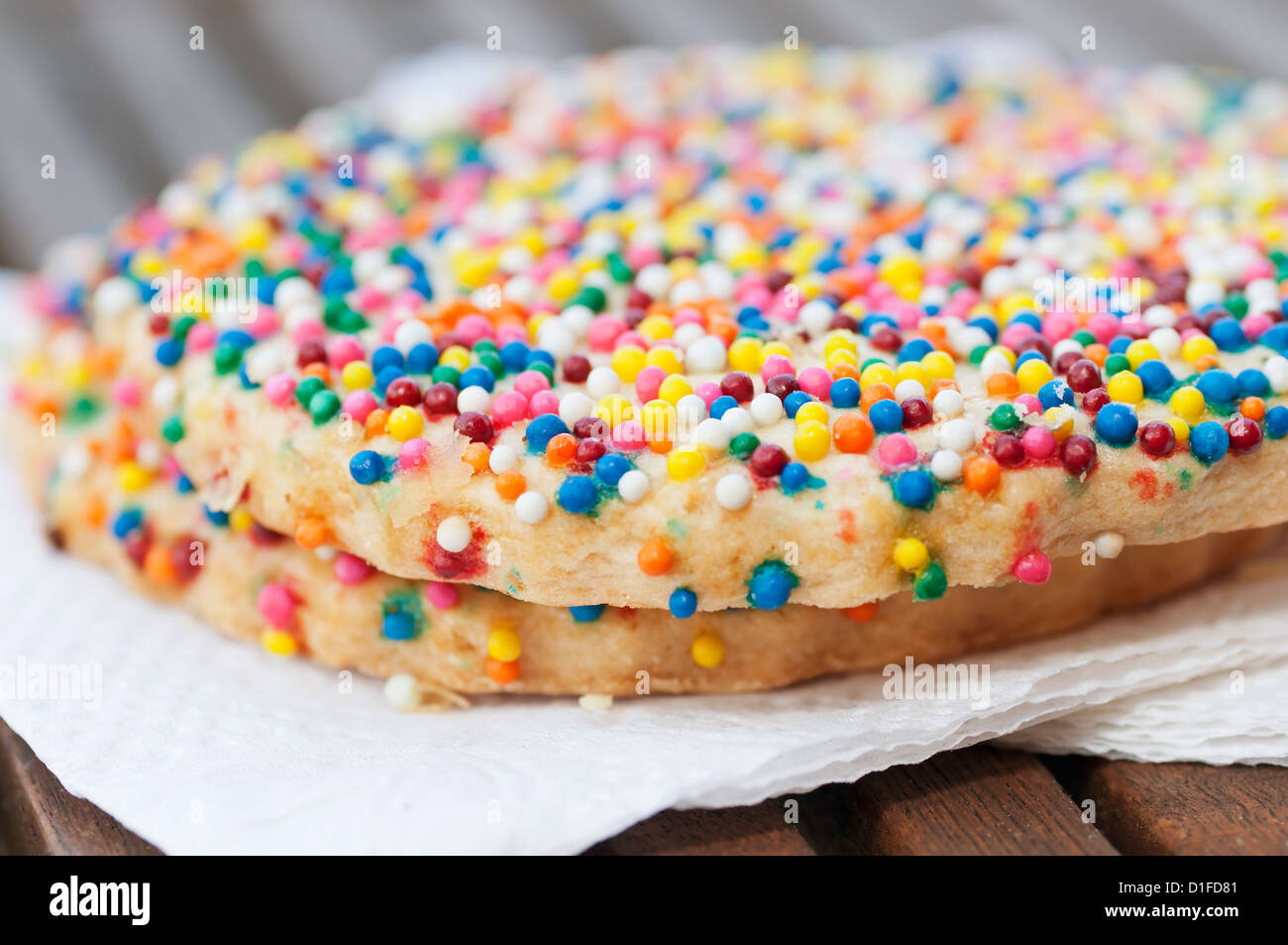 Closeup of two Mexican sugar cookies decorated with colorful candy sprinkles. Stock Photo
