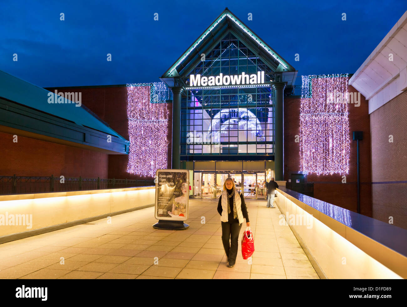 Woman leaving meadowhall shopping centre mall  with christmas shopping bags sheffield south yorkshire england uk gb eu europe Stock Photo