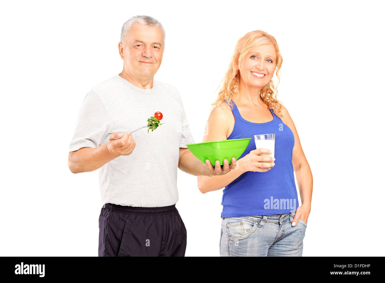 Two mature persons consuming healthy products isolated against white background Stock Photo