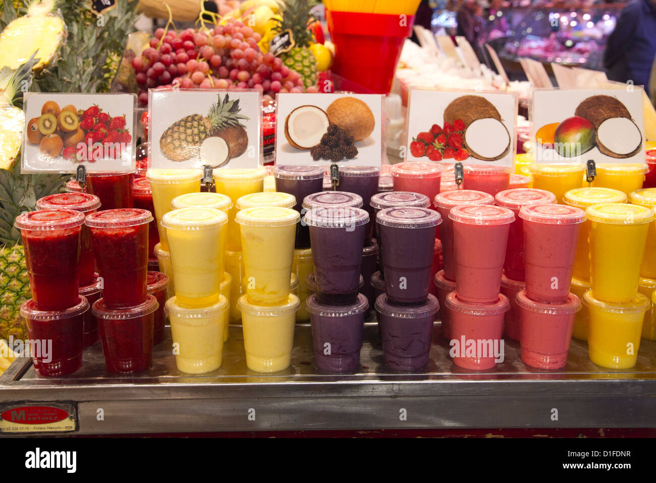 Fruits smoothies and juices stall La Boqueria market Barcelona Spain