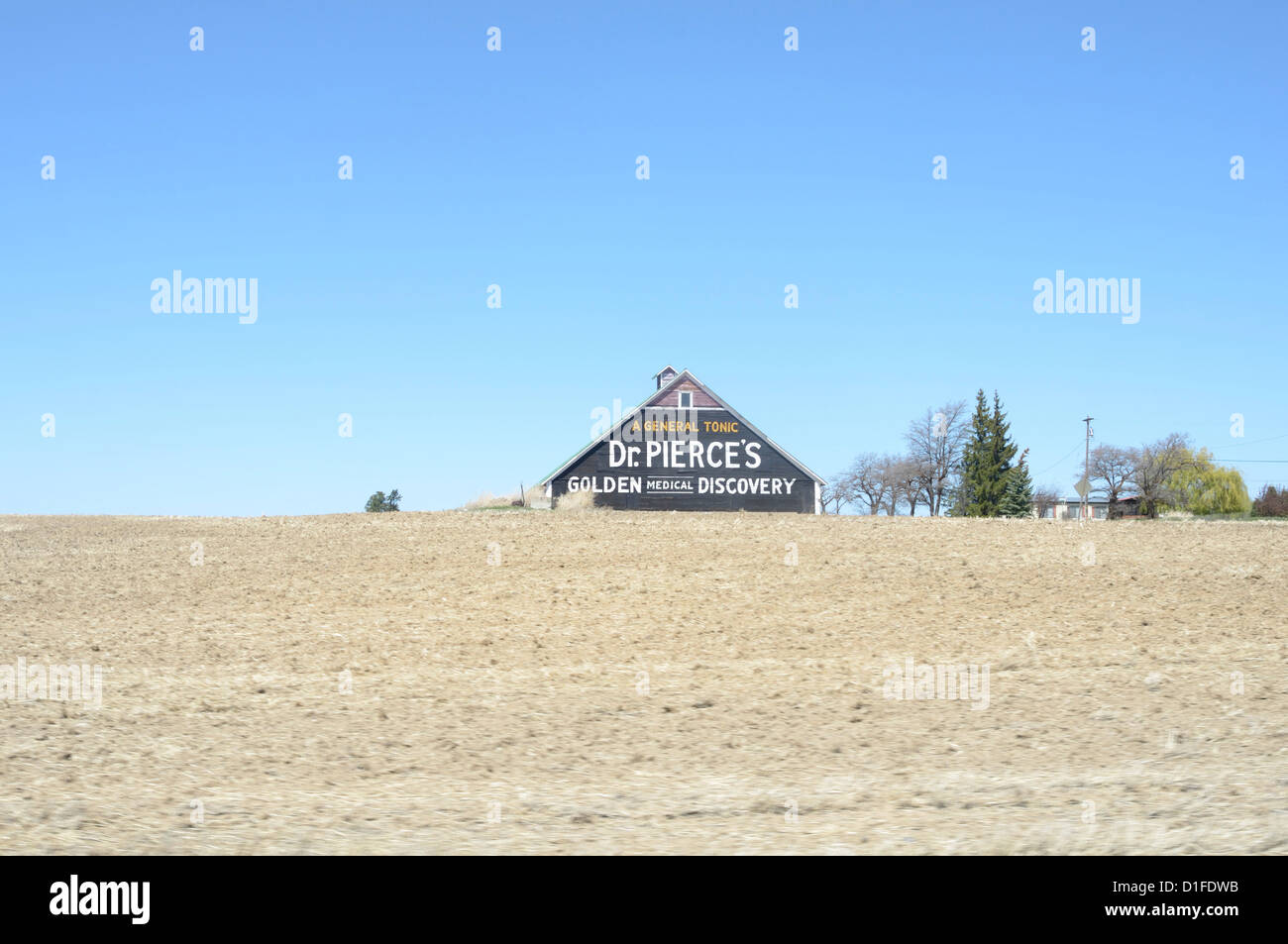 Old advertising on barn with tilled field in foreground, Waterville, Washington State, United States of America, North America Stock Photo