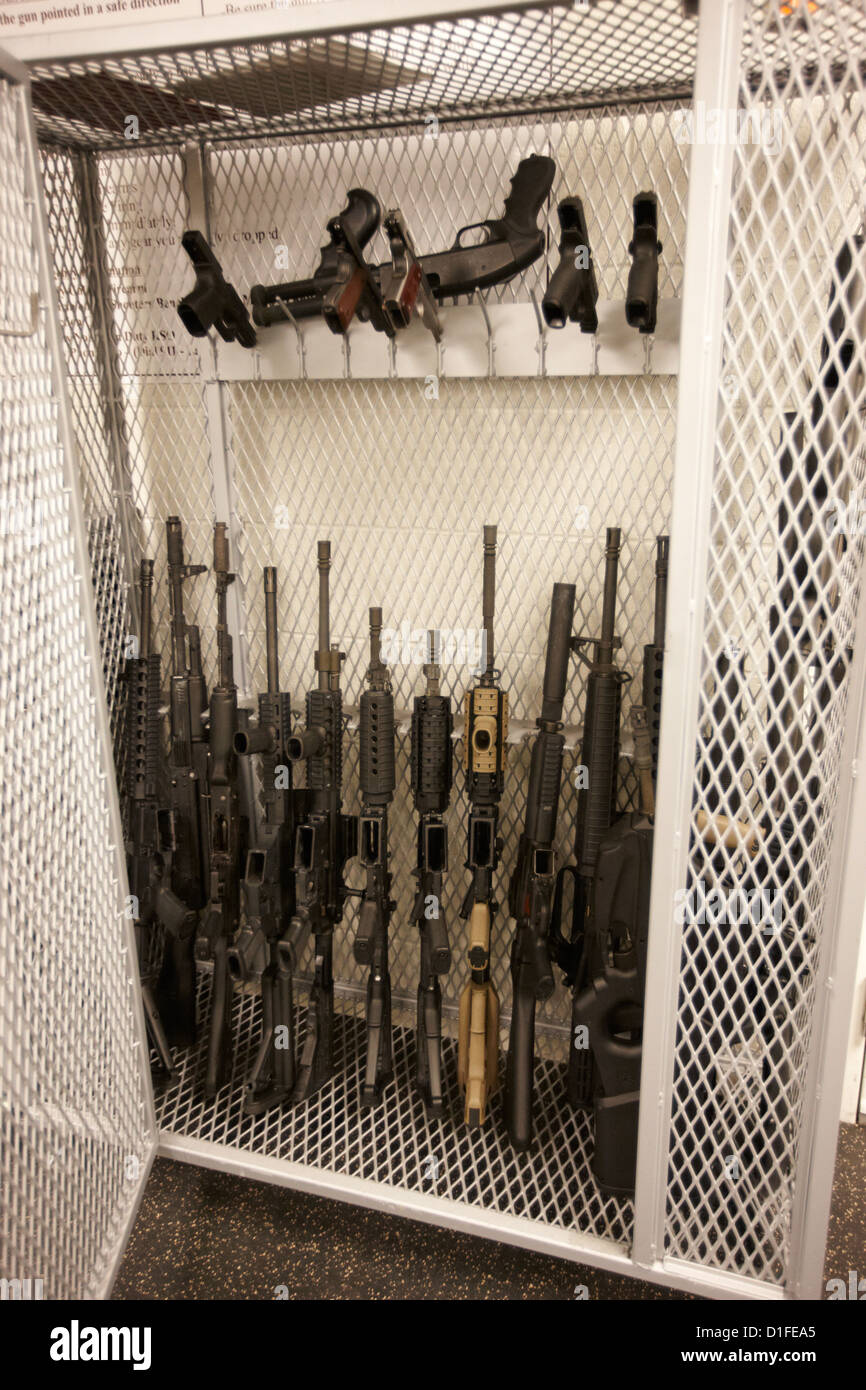 arsenal of weapons cage of assault rifles handguns and shotguns at a gun range in las vegas nevada usa Stock Photo