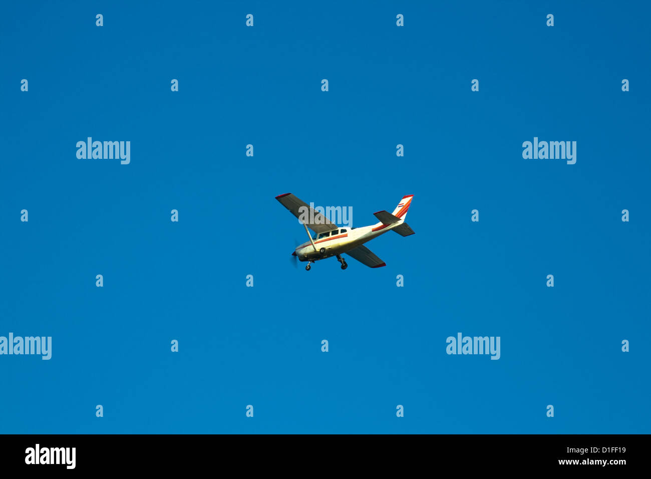 Small plane in flight against blue sky Stock Photo Alamy