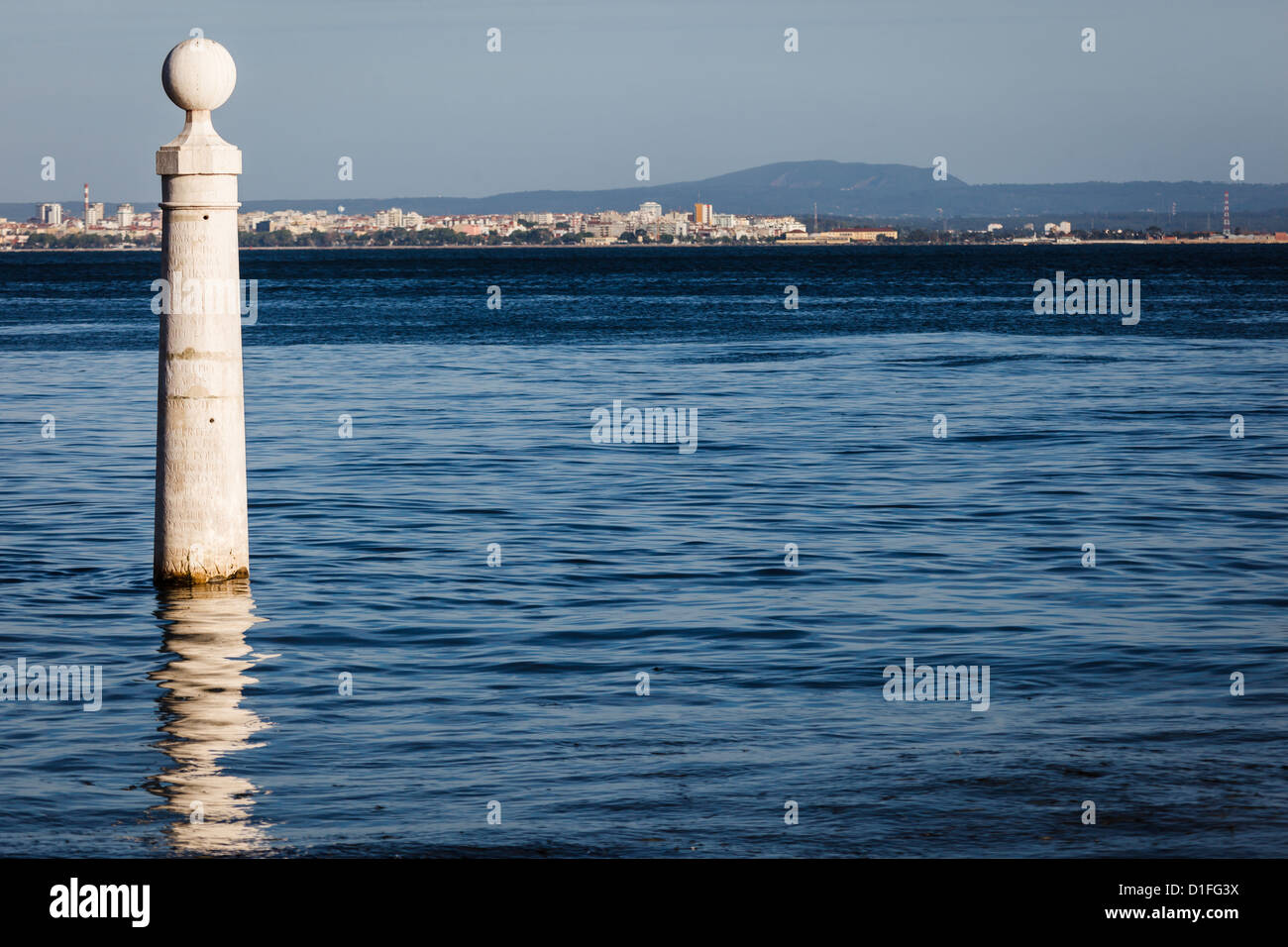 Boat mooring post in Lisbon, Portugal harbor with city in background Stock Photo