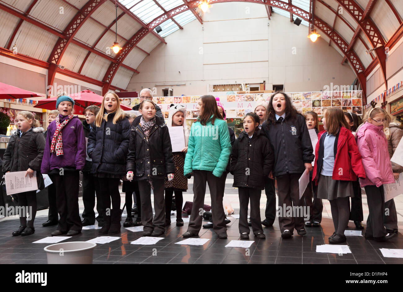 Schoolgirl choir singing Xmas Carols for a charity within the Grainger Market Newcastle  north east England UK Stock Photo