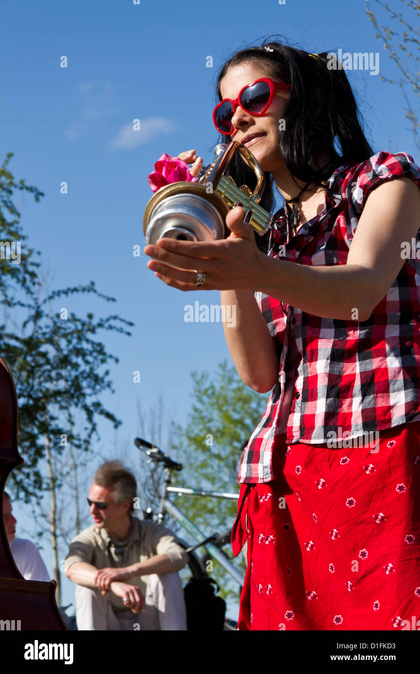 Young Street Musician playing a Trumpet in the Berlin Wall Park