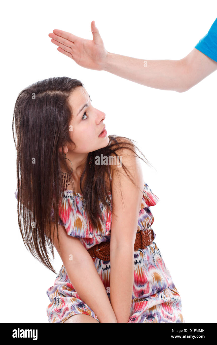 Teenage girl getting a punch from a hand over white background Stock ...