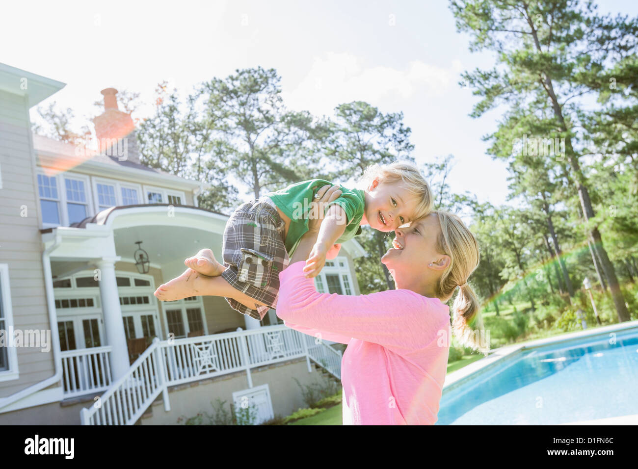 Caucasian mother and son playing in backyard Stock Photo