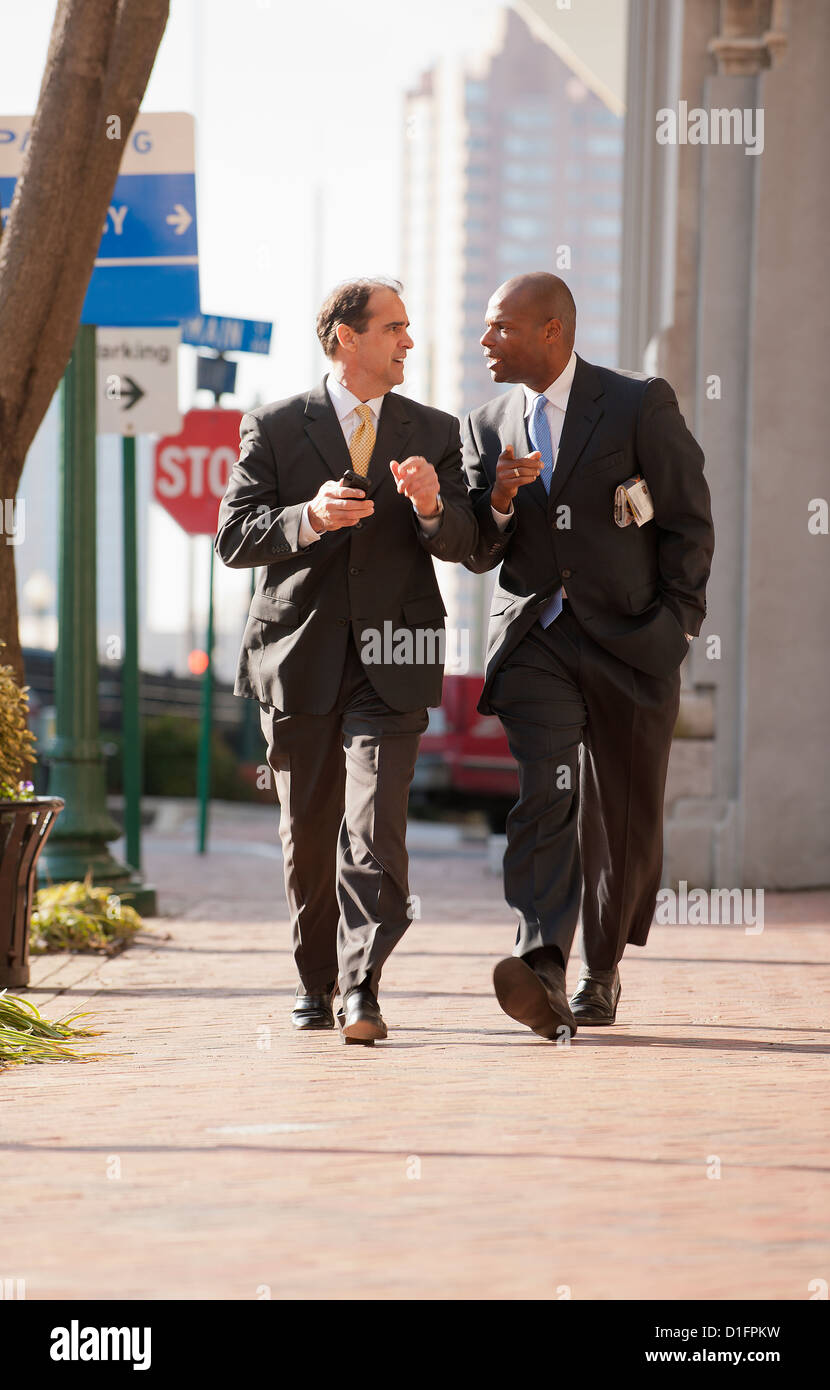 Businessmen walking together on city sidewalk Stock Photo - Alamy