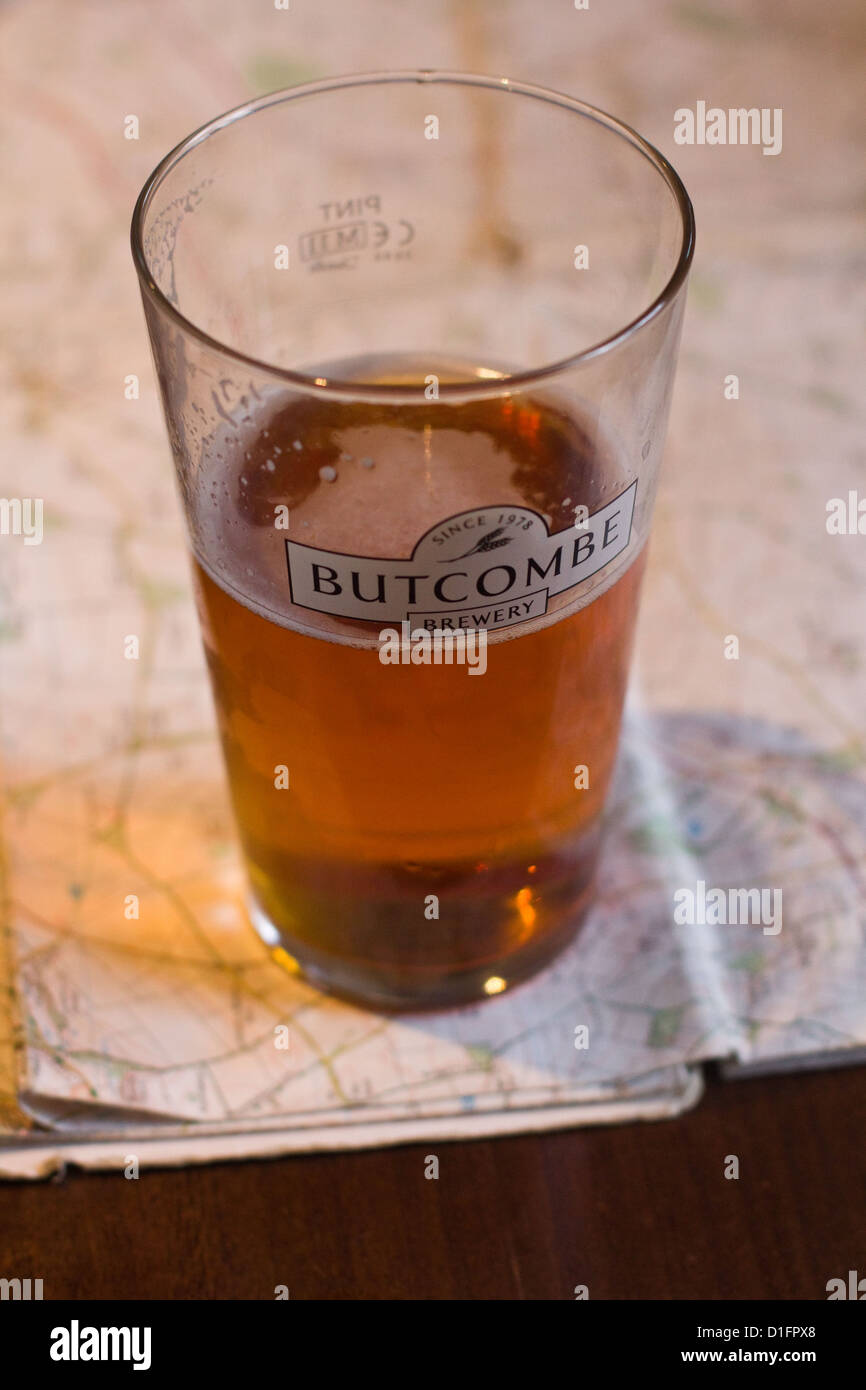 Pint of Butcombe bitter on a walking map in an English village pub Stock Photo