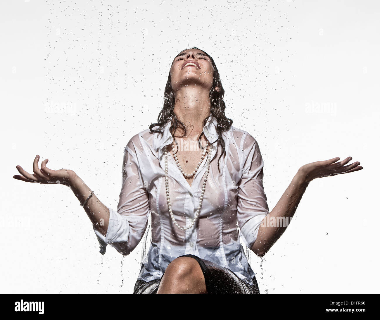 Rain falling on Caucasian businesswoman Stock Photo