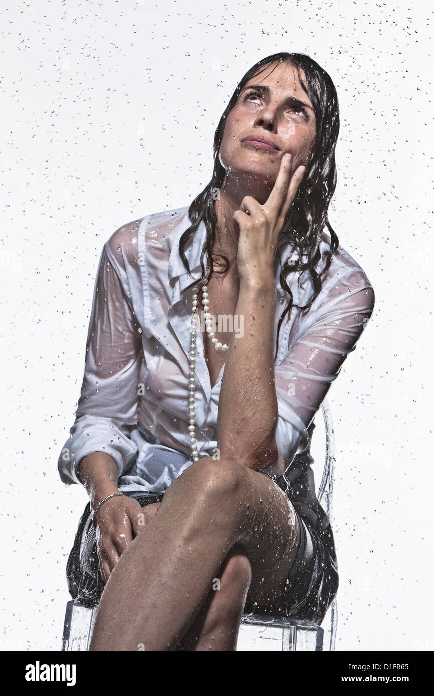 Rain falling on Caucasian businesswoman Stock Photo