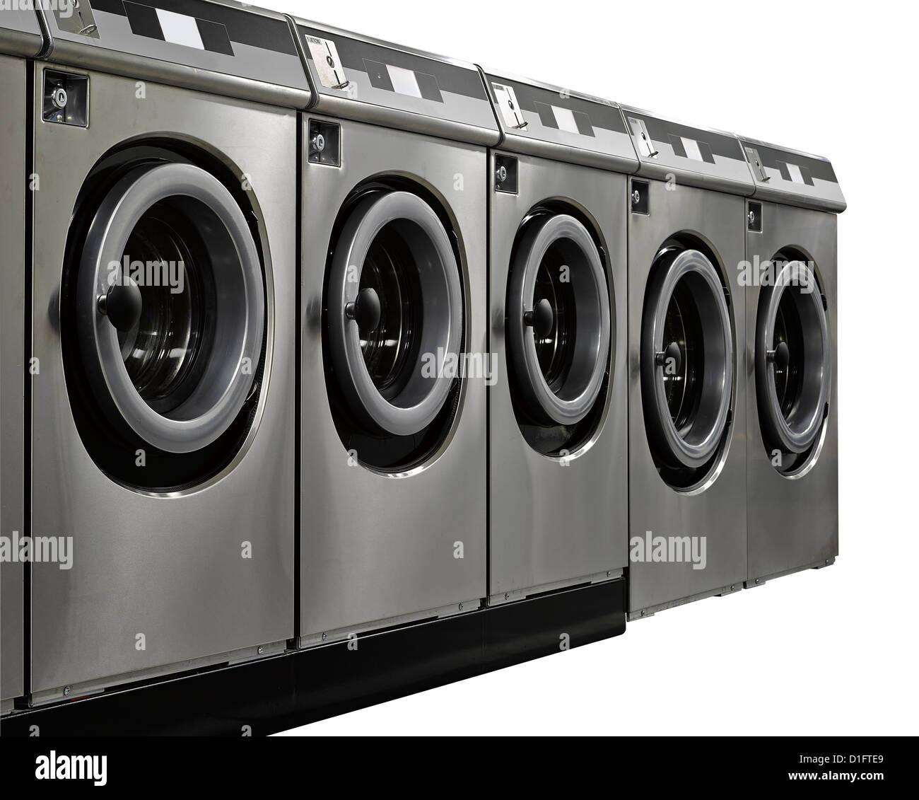 A row of industrial washing machines in a public laundromat Stock Photo