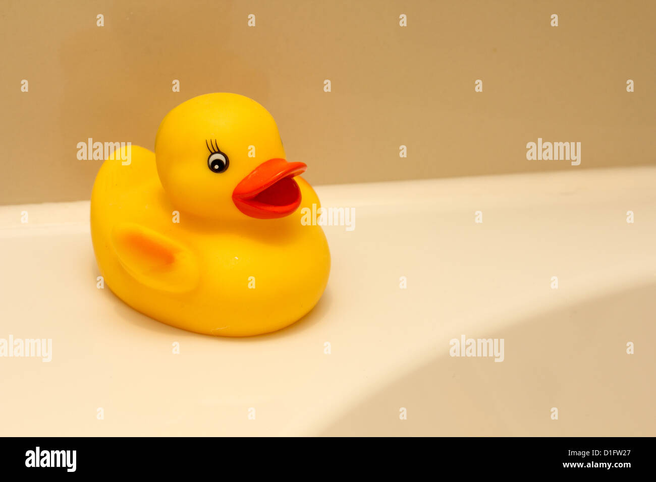 Yellow rubber duck by the side of the bath Stock Photo - Alamy