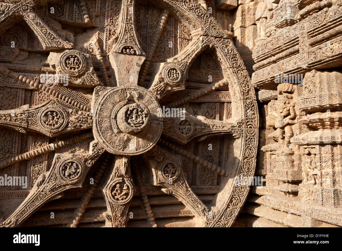 Carved chariot wheel on the wall of the Konarak Sun temple, built as the chariot of Surya the Sun god, Konarak, Orissa, India Stock Photo