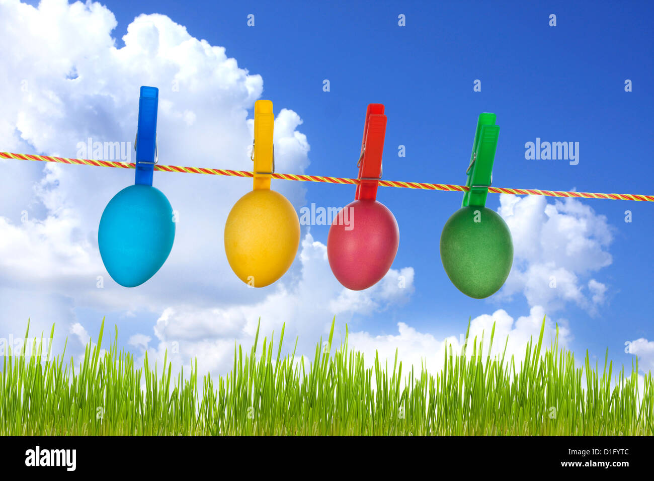 Colorful easter eggs on blue sky and green grass Stock Photo