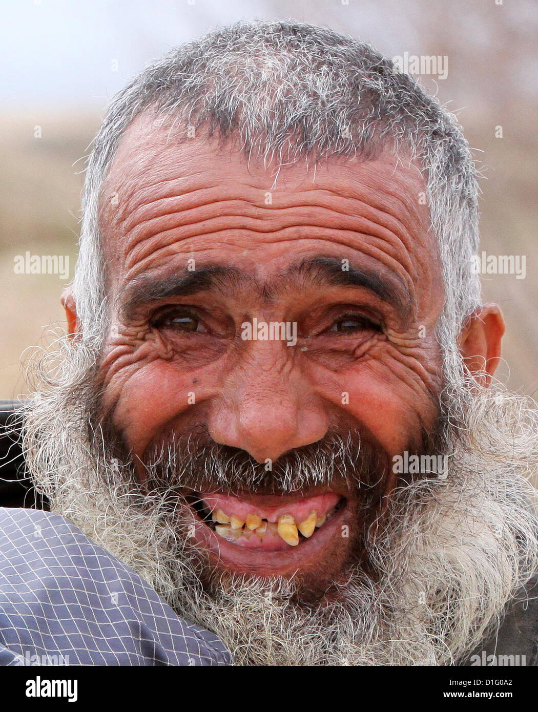 A local Afghan of the Nawbot village smiles for a portrait as US Army  soldiers conduct a routine patrol of his village December 10, 2012 in Puli  Khumri, Afghanistan Stock Photo - Alamy