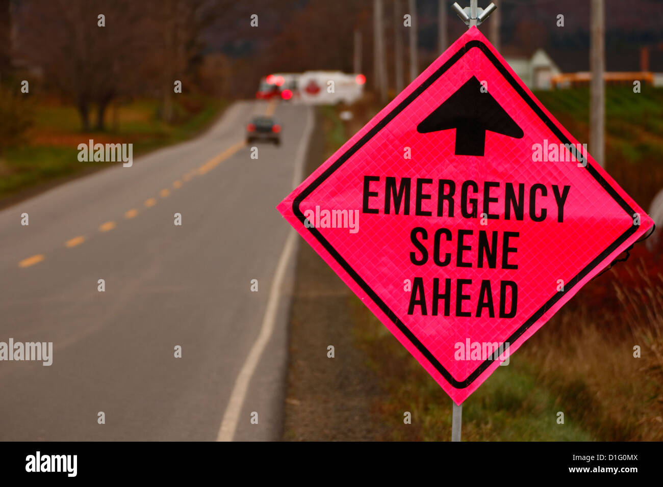 an emergency road sign on a road ahead of an automobile accident Stock Photo