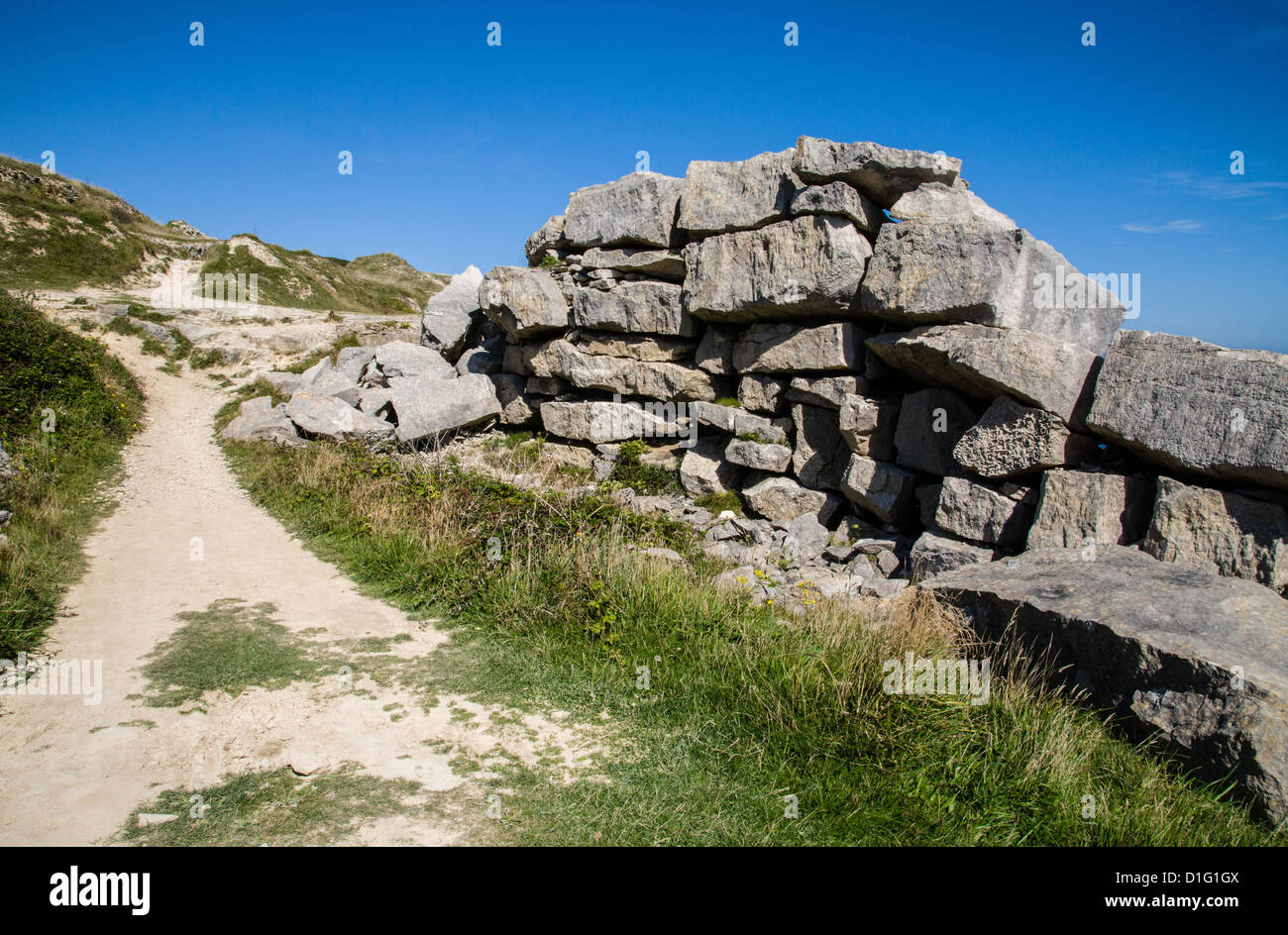 Large blocks of Portland Stone piled up in a quarry on Portland Bill Dorset UK Stock Photo