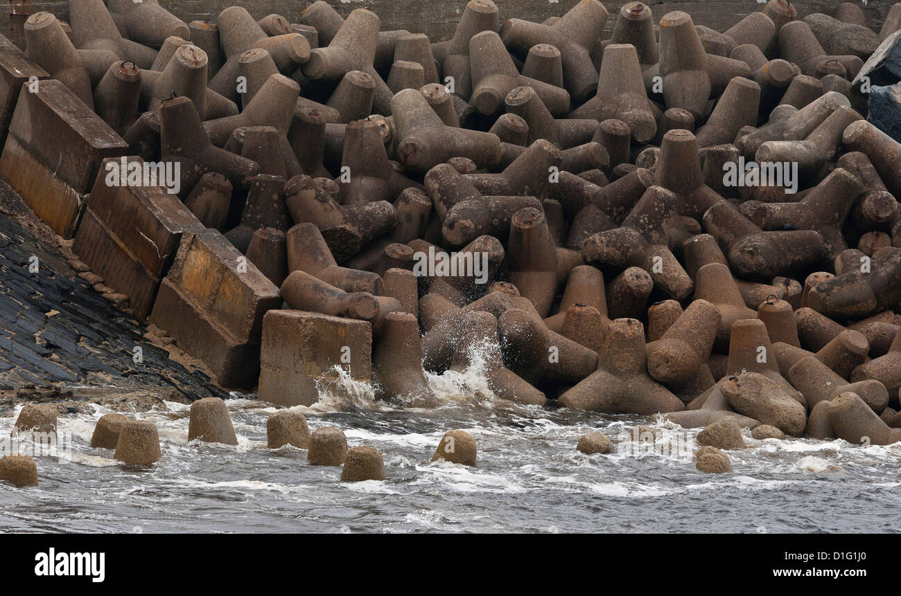 Waves lapping at rip-rap sea defenses in harbour at Wick, Scotland. Stock Photo