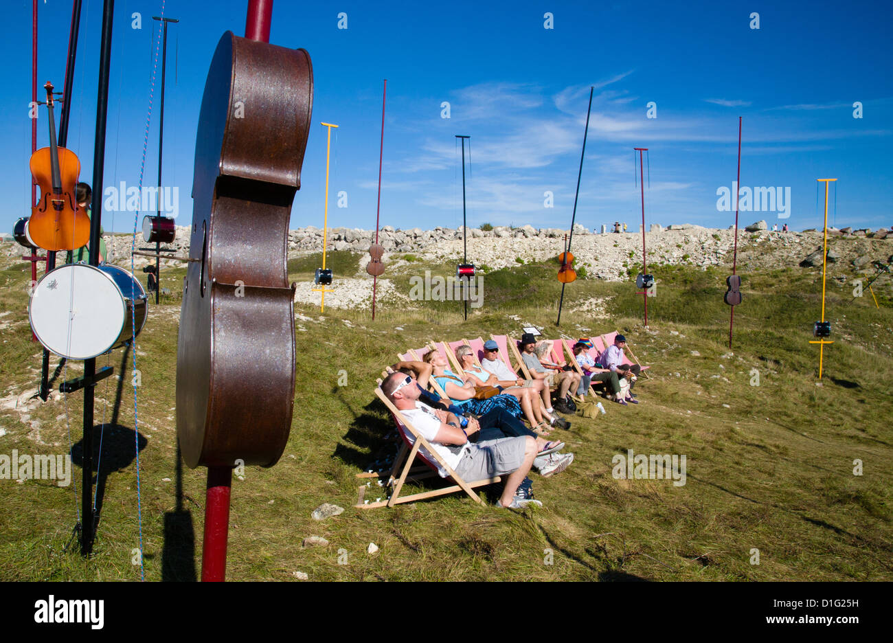 An audience in deck chairs listening to aeolian music from various instruments at Harmonic