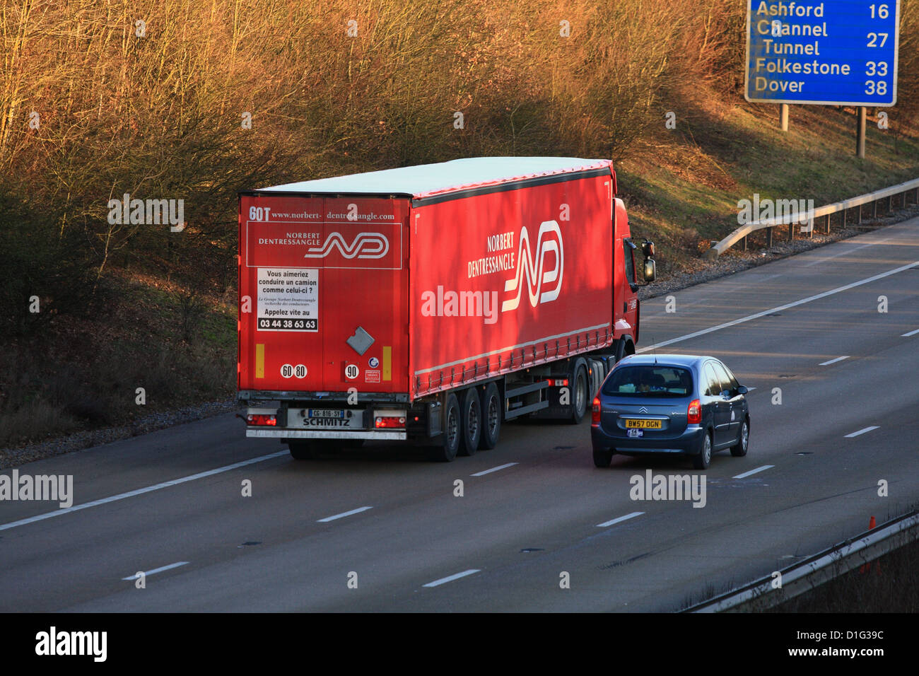 A truck and car traveling along the M20 motorway in Kent Stock Photo