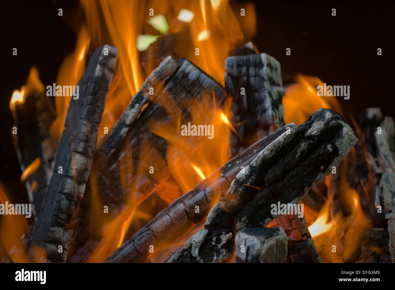 Middle of a wood fire with flames and glowing embers, closeup Stock Photo