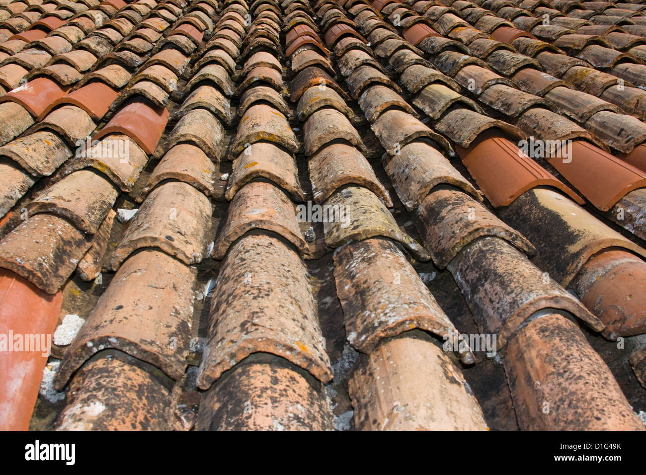 A portion of roof of old-stile bent tiles repaired with new ones Stock Photo
