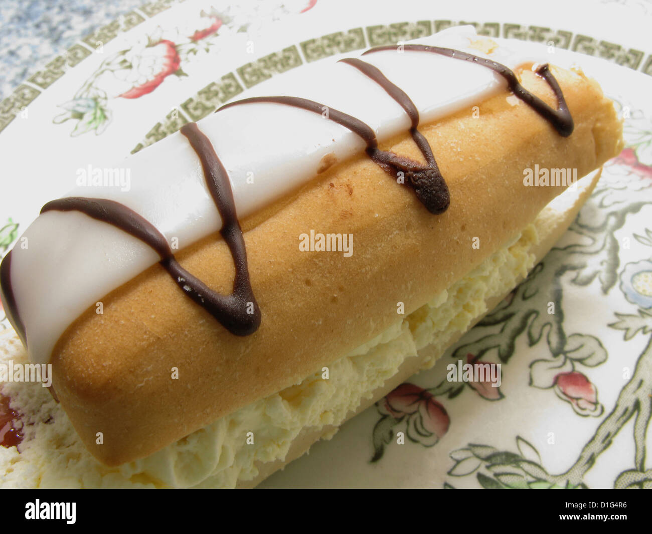 Iced cream bun on a plate as a teatime treat Stock Photo