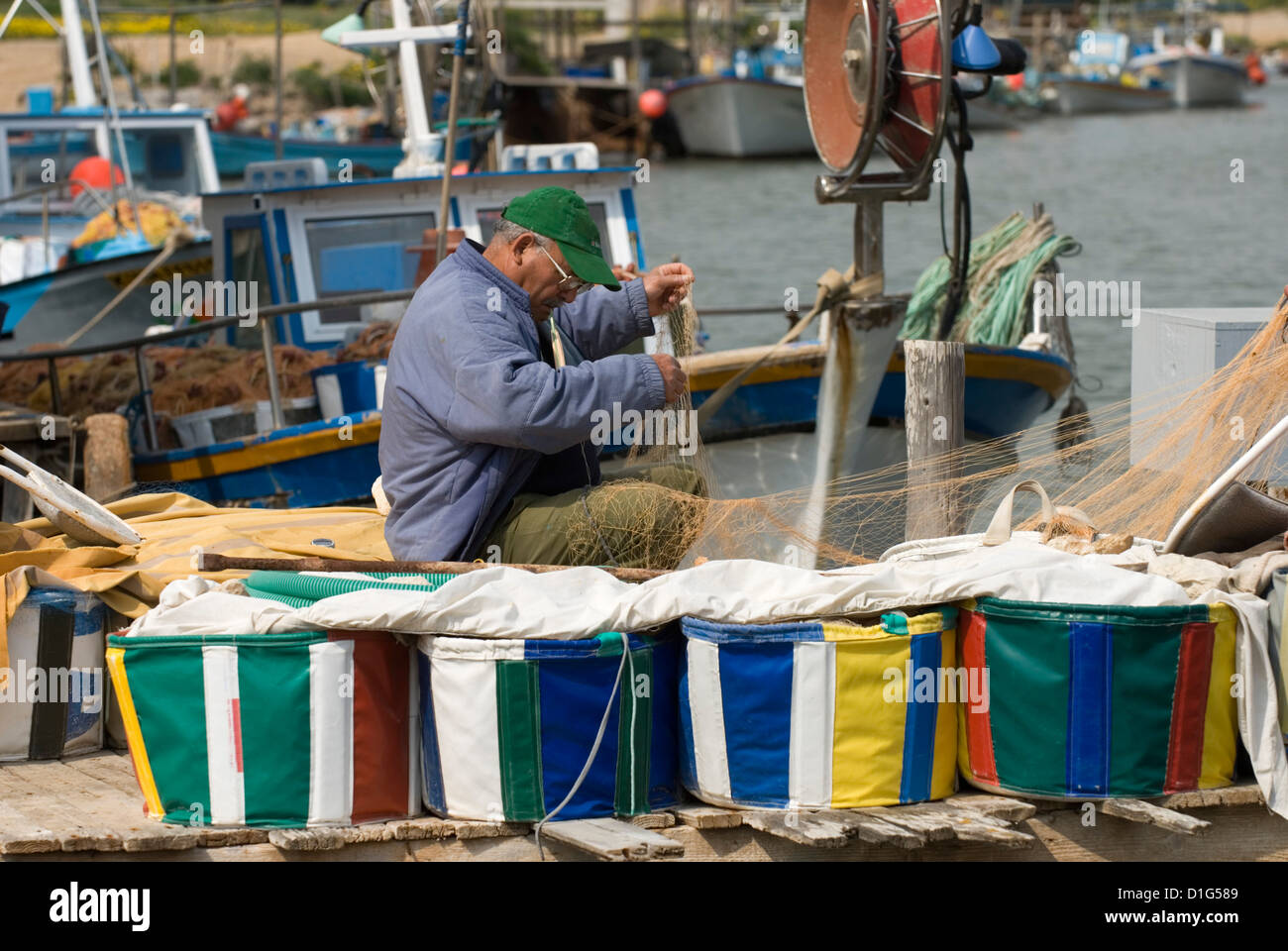Fisherman mending nets, Potamos Tou Liopetri, Cyprus, Europe Stock Photo