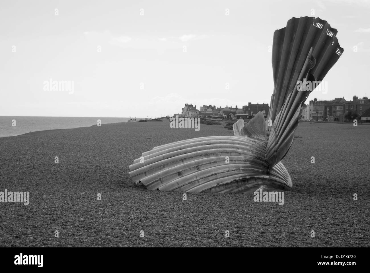 A black and white image of The Scallop sculpture by Maggi Hambling on Aldeburgh Beach Stock Photo