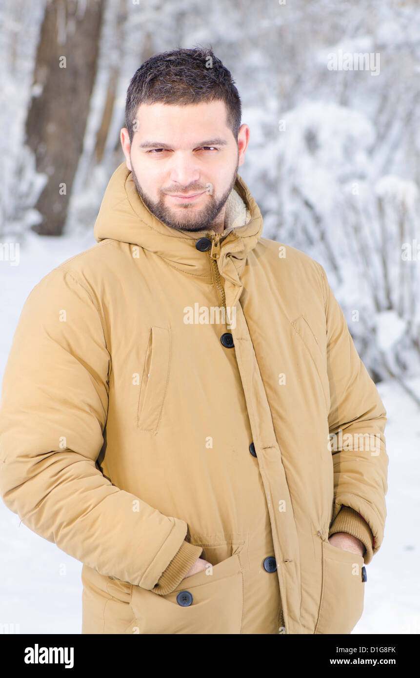 A young handsome guy in the forest during winter Stock Photo - Alamy