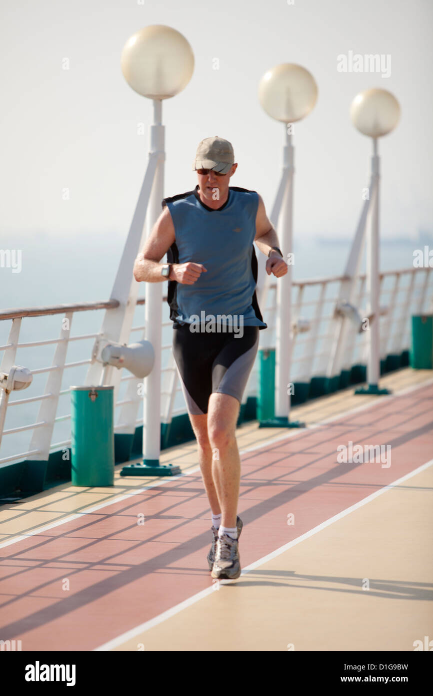 Man running on cruise deck. Stock Photo