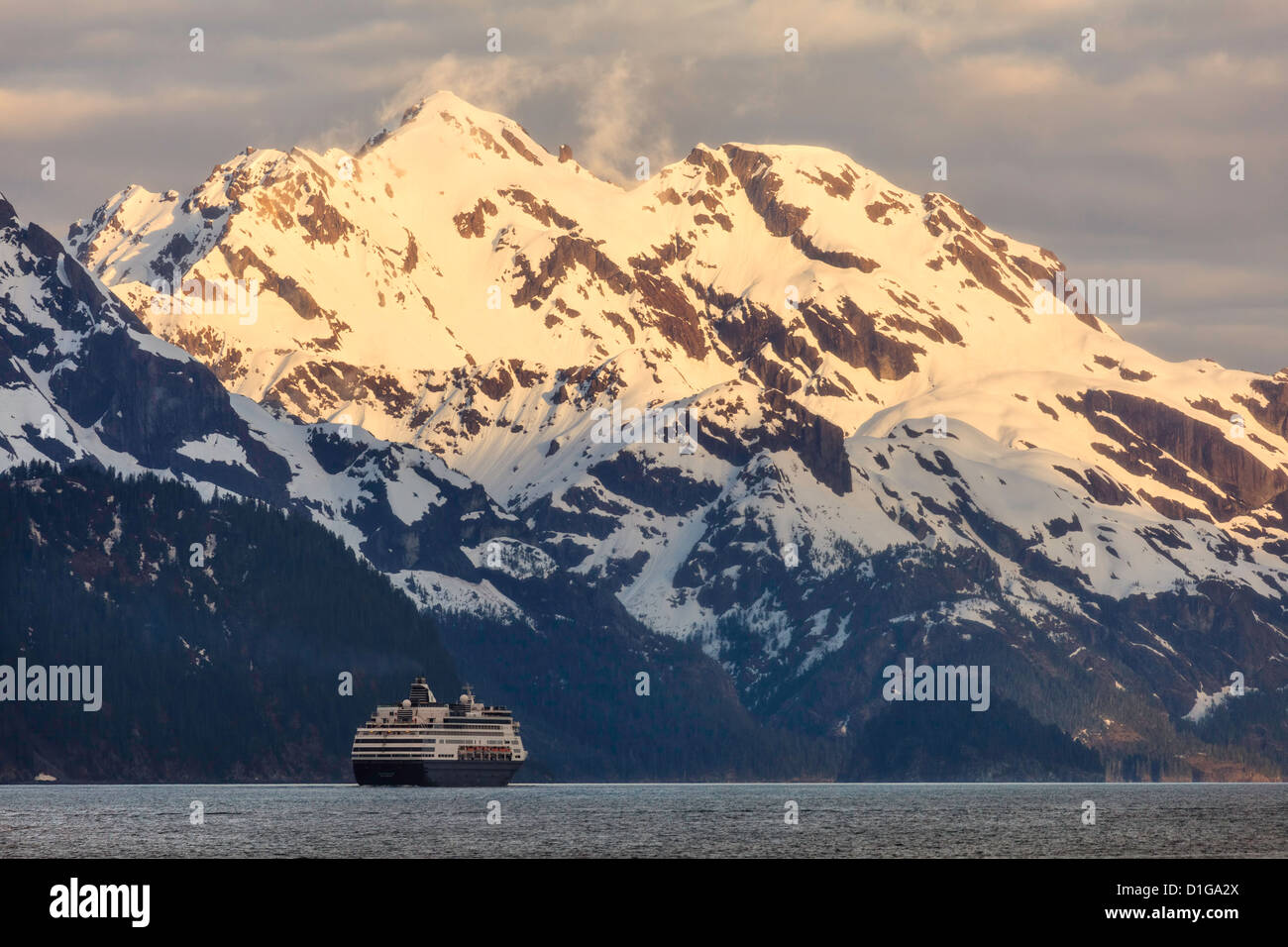 A cruise ship in Resurrection Bay with the Resurrection Mountains in the background as it departs Seward, Alaska. Stock Photo