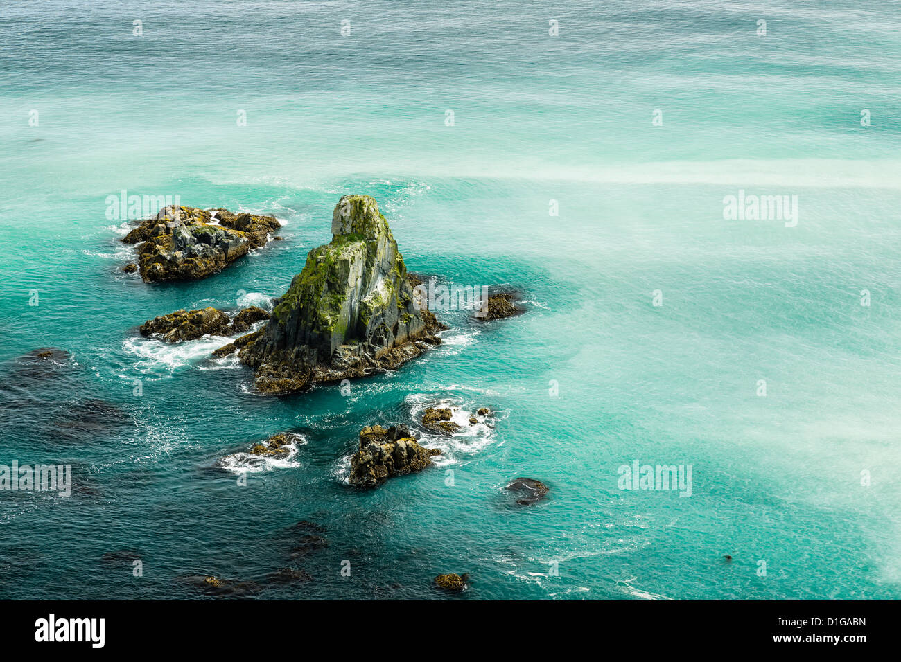 A plankton bloom in the Gulf of Alaska and sea stacks off Pasagshak Point on Kodiak Island in Southwestern Alaska. Stock Photo