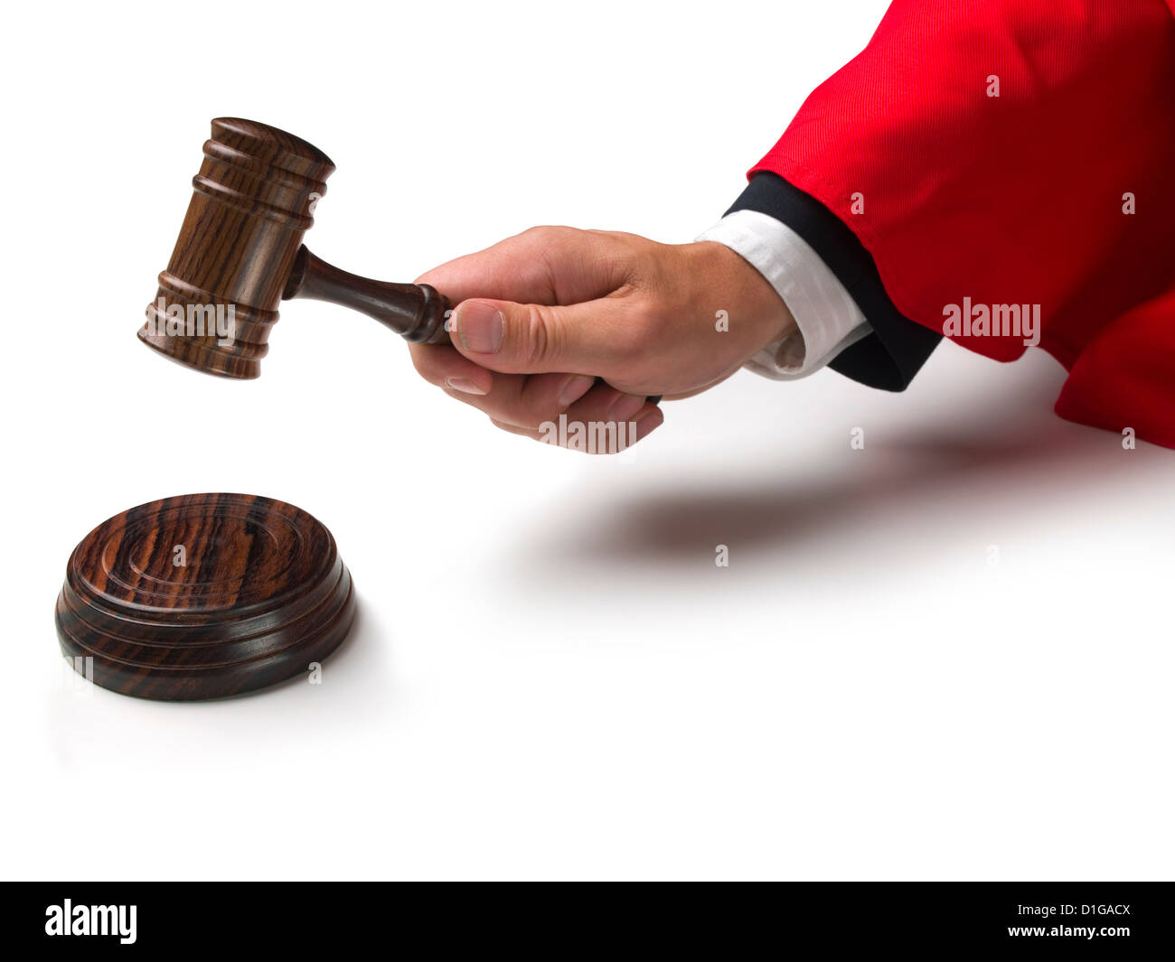 Law court judge's hand wearing red gown sleeve banging a gavel down