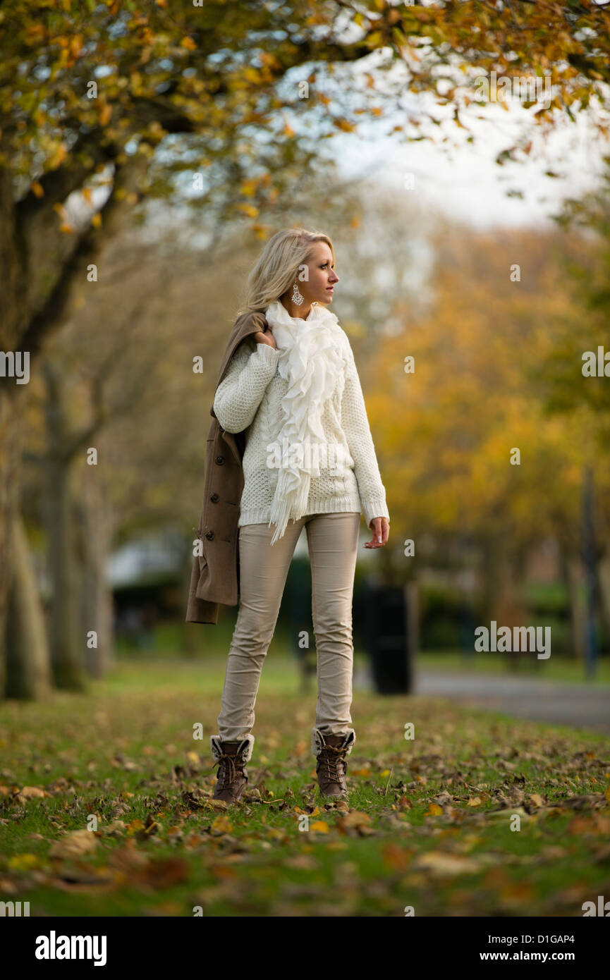 A 16 17 year old blonde slim teenage girl, walking in the park on an autumn  afternoon, UK Stock Photo - Alamy