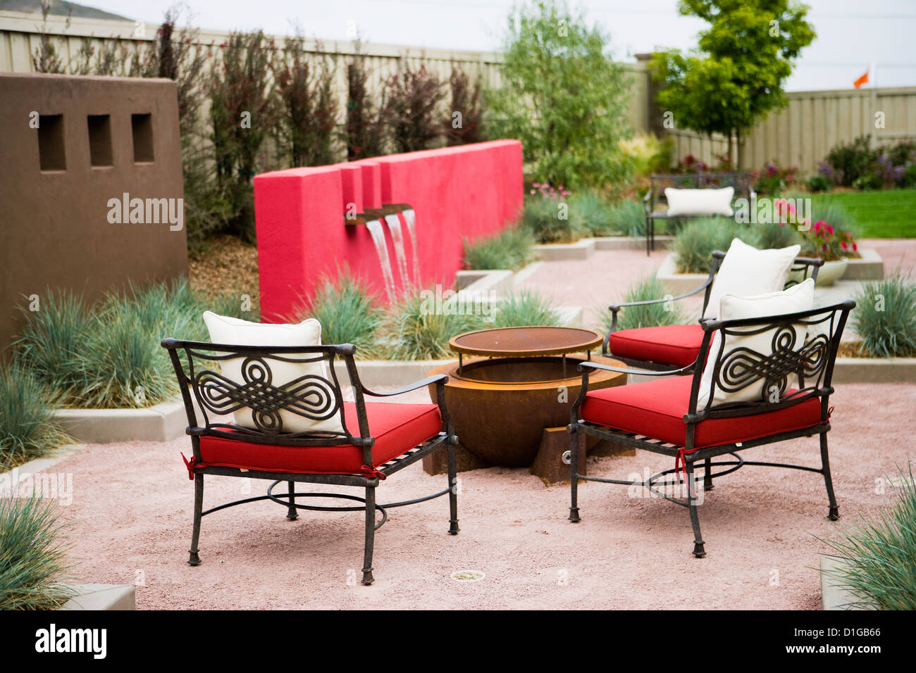 Wrought iron chairs surrounding fire pit in back yard; San Diego