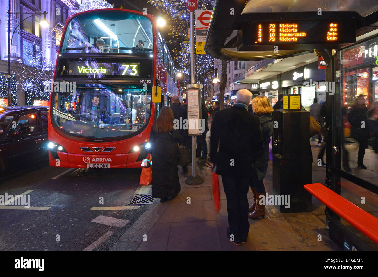 Double decker bus at stop in Oxford Street with Christmas lights Stock Photo
