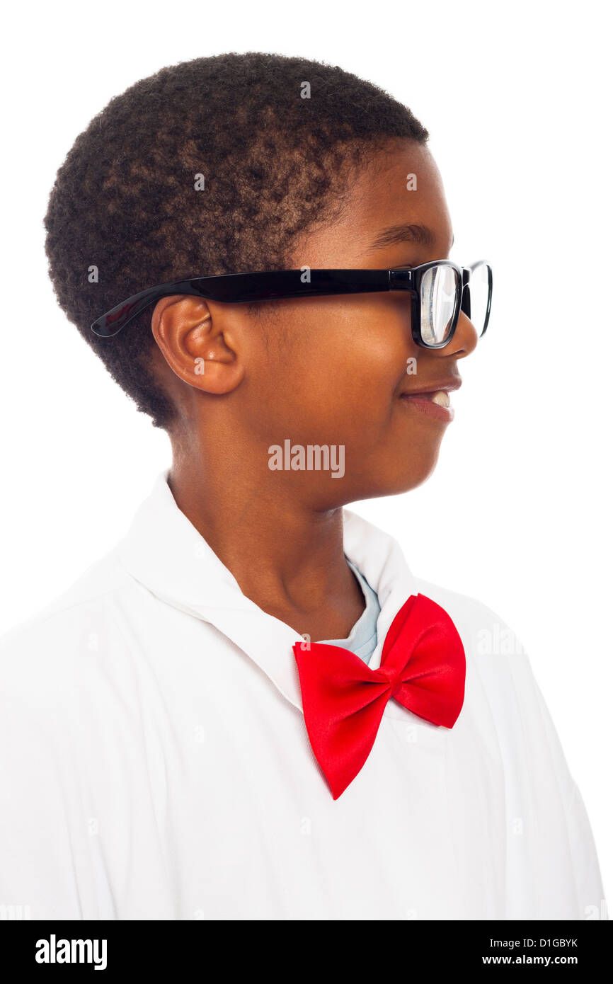 Profile of happy clever school boy in scientist lab coat, red bow tie and black eyeglasses, isolated on white background. Stock Photo